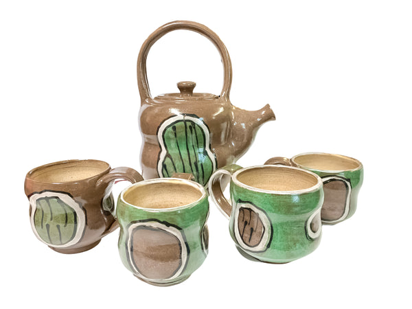 teapot with caterpillar decoration and cup set